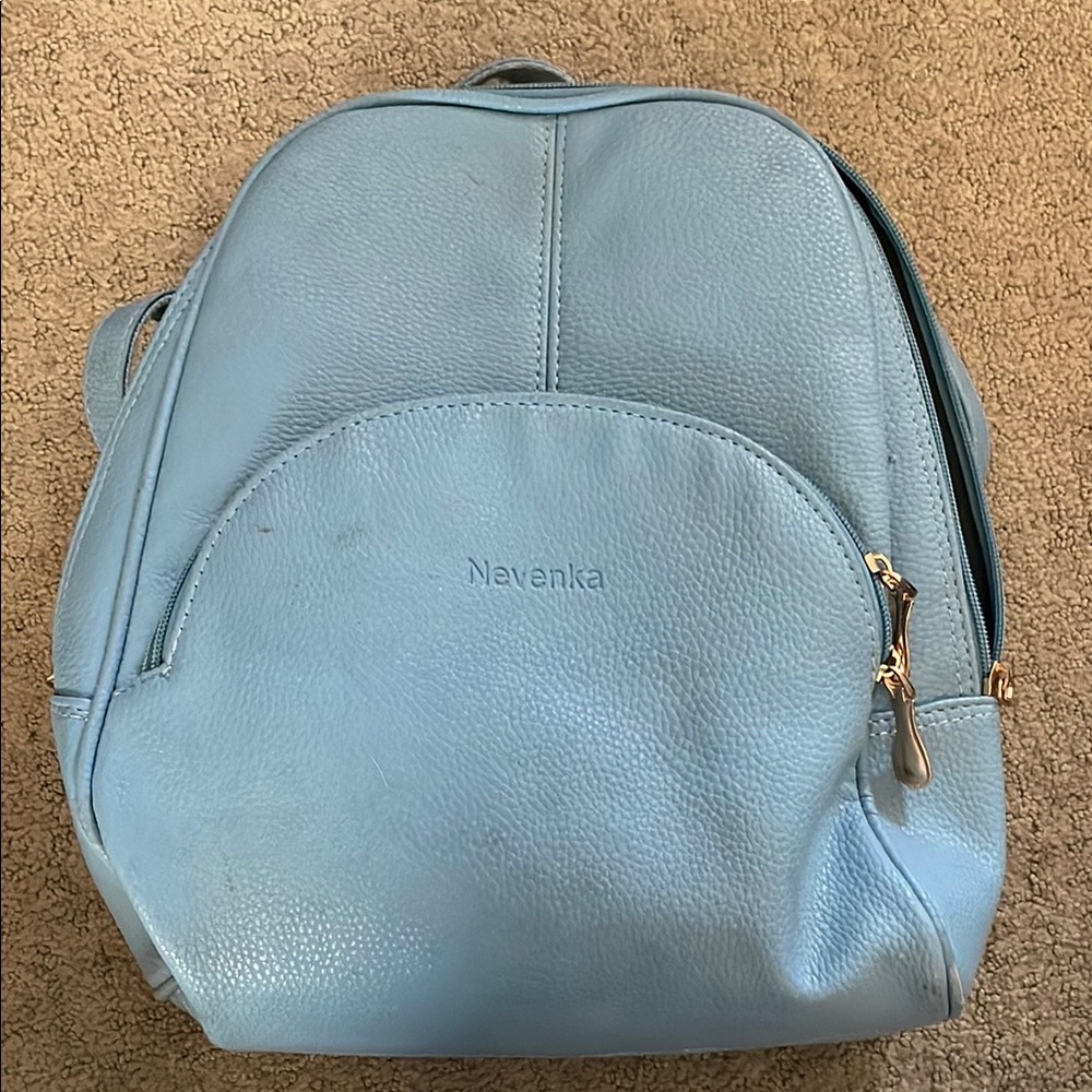 Pastel Blue Backpack with Textured Material and Rounded Shape